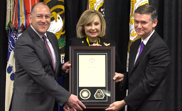 Cathy Dickens receiving her plaque from the Hon. Gabe Camarillo and Doug Bush.