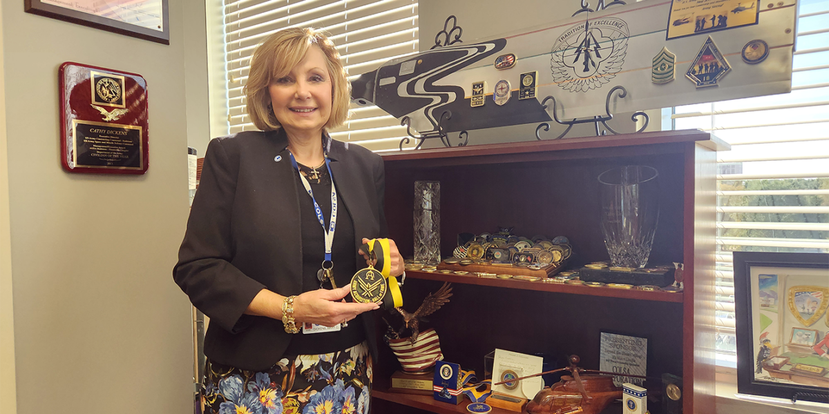 Ms. Cathy Dickens and her collection of awards.