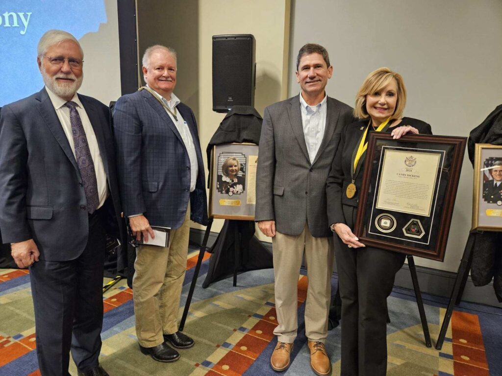 Stan Soya, Barry Gosnell, James Kennedy, and Cathy Dickens with her plaques.